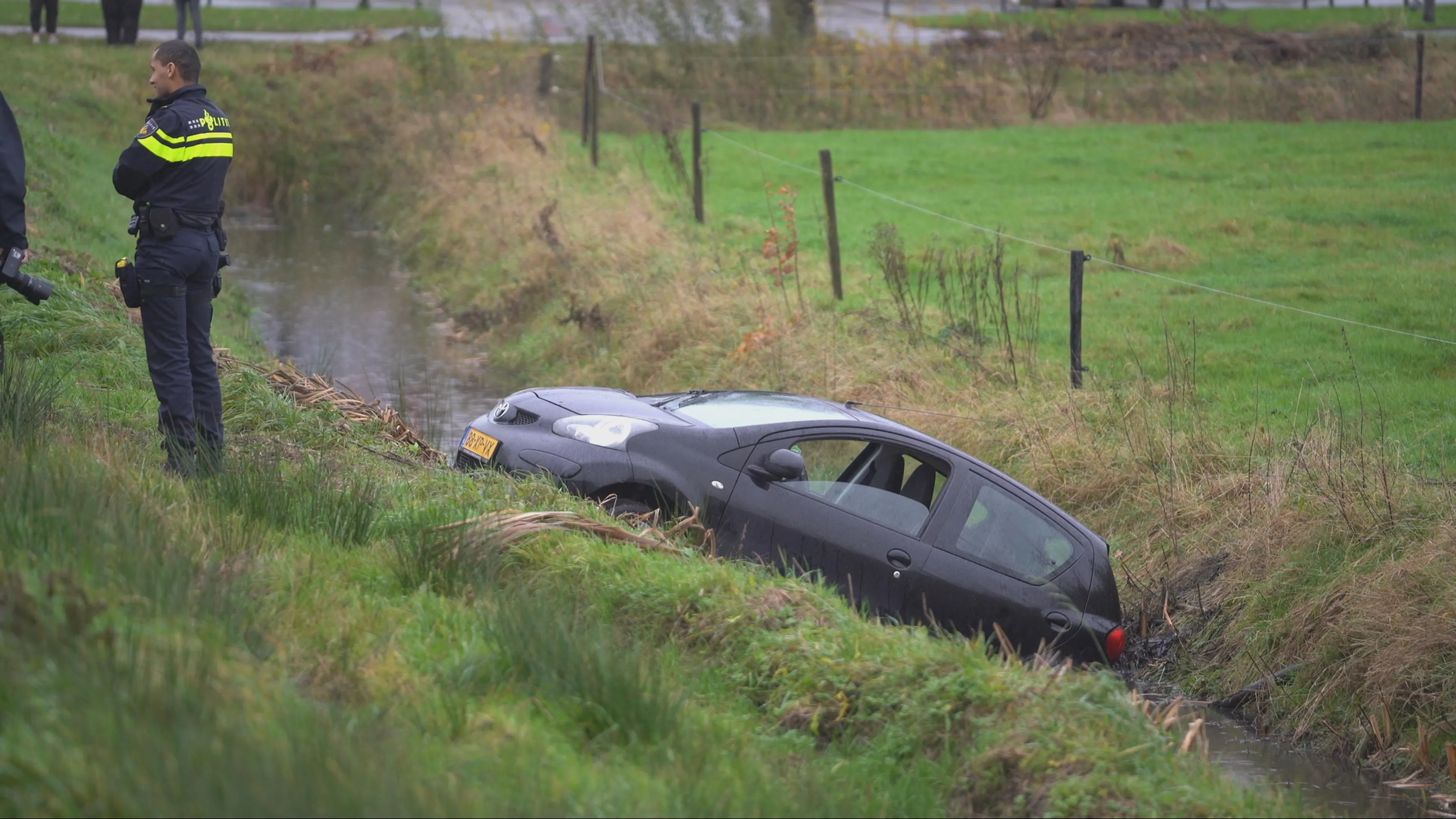 Auto in sloot bij Leek: vrouw moet in water wachten op hulp