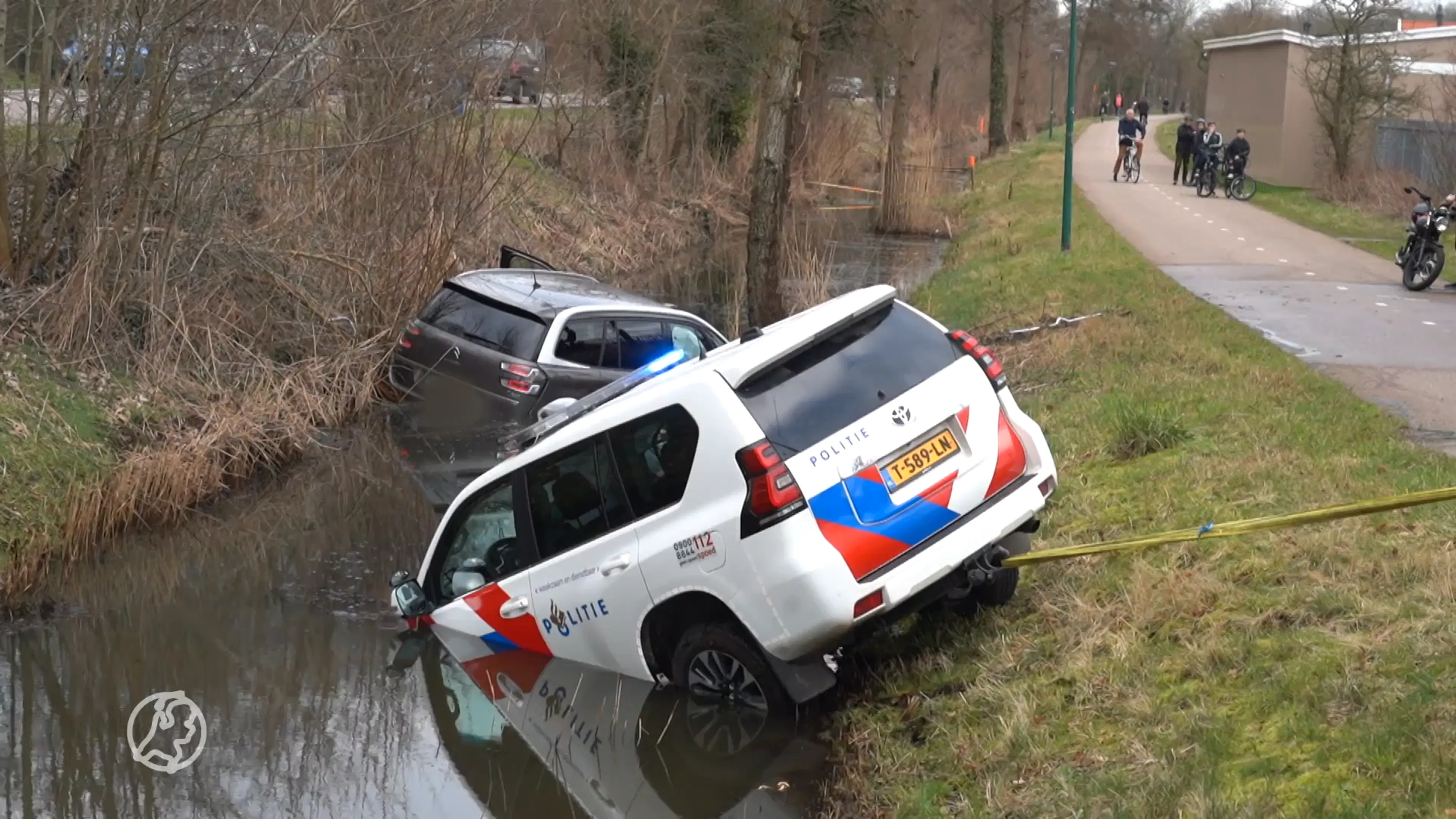 Auto rijdt in sloot, politie vergeet handrem en rijdt ook sloot in