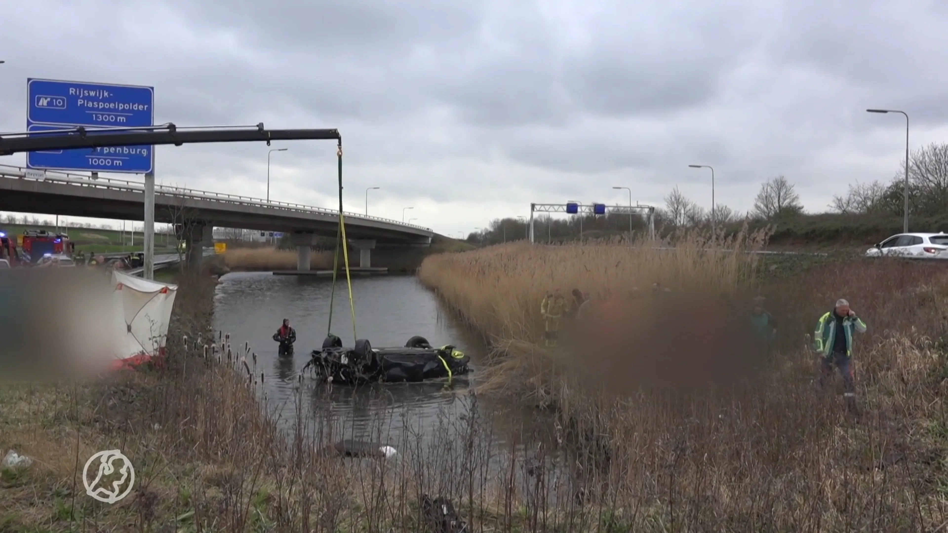 Auto op zijn kop in water op A12, twee personen gewond